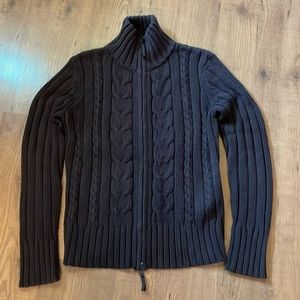 Ricki’s brown knit cardigan.